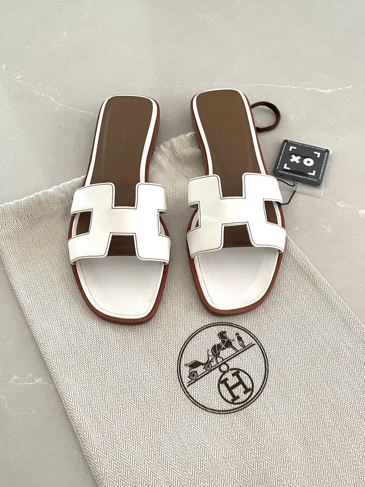 Hermès Oran sandals in white leather