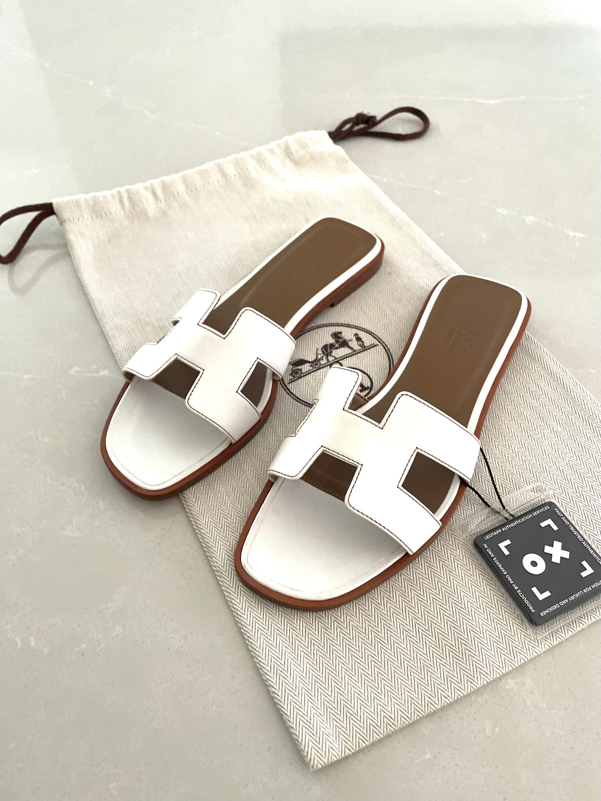 Hermès Oran sandals in white leather